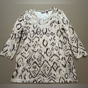 Chicos top in fun leopard print. Embellished with sequins around v-neck. Size 0